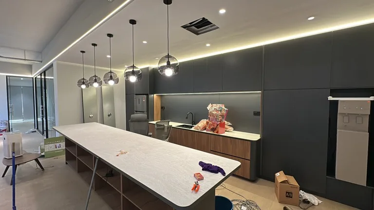 Completed office pantry with island counter and pendant lighting