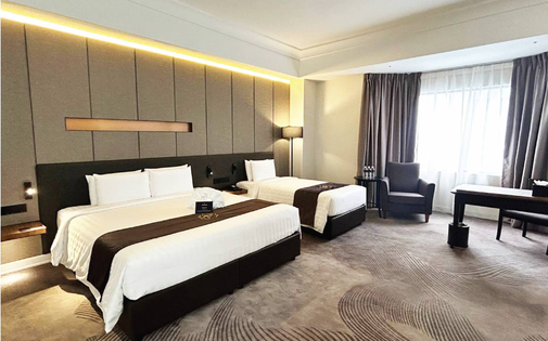 Completed Pearl Point Hotel twin room with upholstered headboard