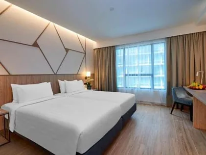 Completed hotel guest room with geometric timber headboard detail