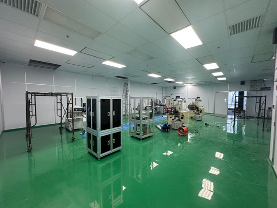 Industrial cleanroom with green epoxy floor and coordinated ceiling services